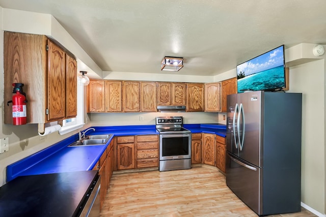 882 Diamond Creek Rd, Newport, WA 99156 - kitchen featuring appliances with stainless steel finishes, brown cabinets, and light wood-style flooring