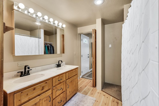 882 Diamond Creek Rd, Newport, WA 99156 - bathroom featuring wood finished floors and double vanity