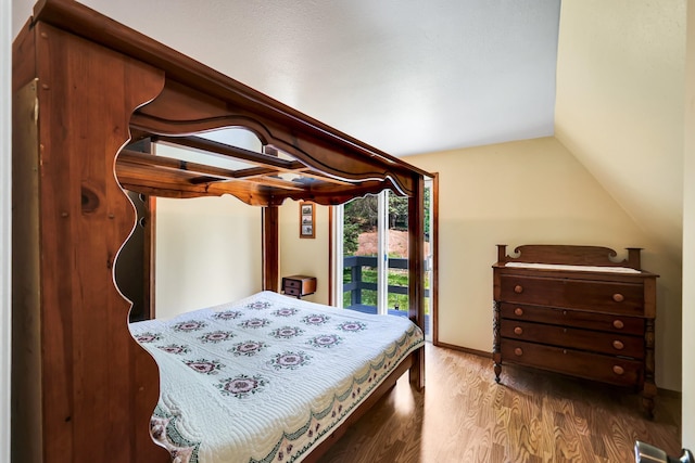 882 Diamond Creek Rd, Newport, WA 99156 - bedroom with wood finished floors, vaulted ceiling, and access to outside