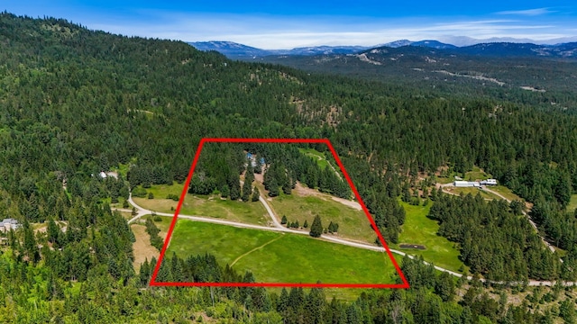 882 Diamond Creek Rd, Newport, WA 99156 - aerial overview of property's location featuring a mountain backdrop and property boundaries highlighted