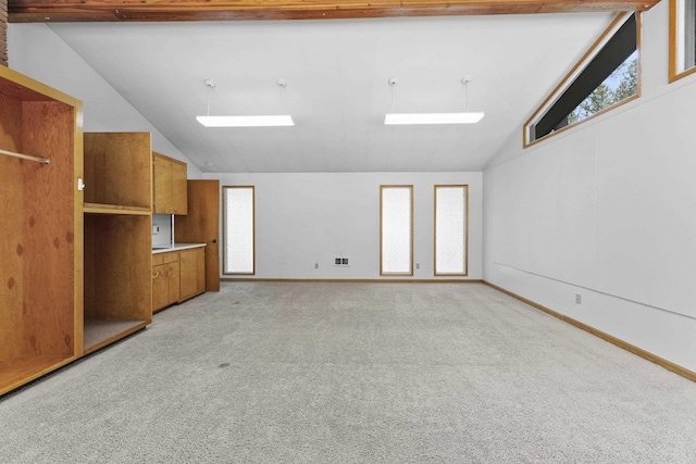 812 W Westover Rd, Spokane, WA 99218 - unfurnished living room featuring lofted ceiling, a skylight, light colored carpet, and plenty of natural light