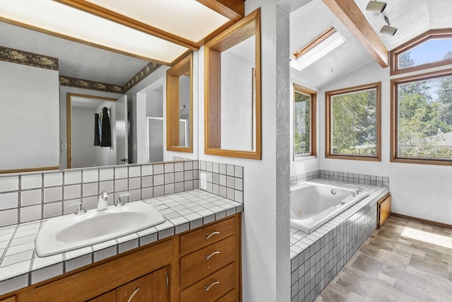 812 W Westover Rd, Spokane, WA 99218 - bathroom featuring vaulted ceiling, vanity, a jetted tub, and decorative backsplash