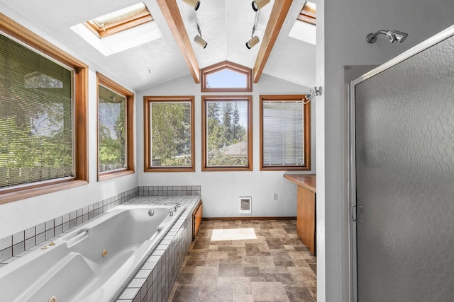 812 W Westover Rd, Spokane, WA 99218 - bathroom with a skylight, a jetted tub, a shower stall, lofted ceiling, and stone finish flooring