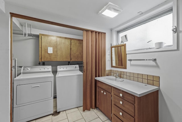 812 W Westover Rd, Spokane, WA 99218 - laundry area featuring washing machine and clothes dryer, cabinet space, and light tile patterned floors