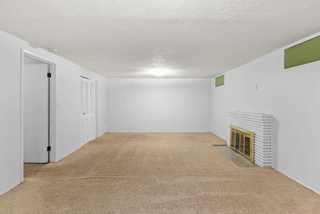 812 W Westover Rd, Spokane, WA 99218 - unfurnished living room with carpet, a brick fireplace, and a textured ceiling