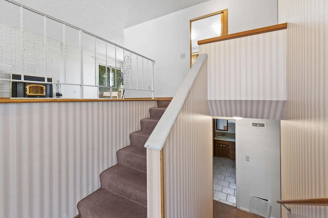 812 W Westover Rd, Spokane, WA 99218 - staircase featuring a textured ceiling