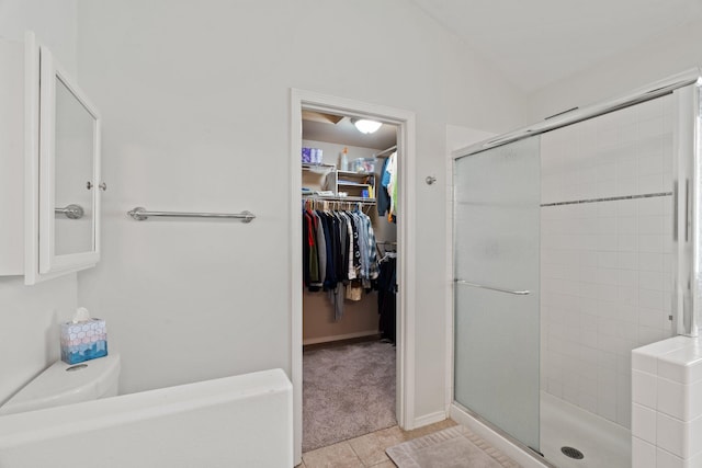 6610 S Echo Ridge St, Spokane, WA 99224 - bathroom with a stall shower, a spacious closet, and tile patterned flooring
