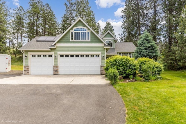 1629 S Royal St, Spokane, WA 99224 - view of front of home with a front yard, stone siding, solar panels, and concrete driveway
