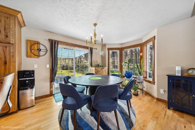 1629 S Royal St, Spokane, WA 99224 - dining area featuring a chandelier, light wood-style flooring, and a textured ceiling
