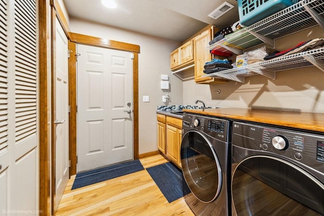 1629 S Royal St, Spokane, WA 99224 - laundry room featuring independent washer and dryer, light wood-style flooring, and cabinet space