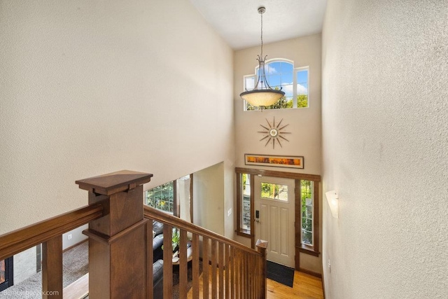 1629 S Royal St, Spokane, WA 99224 - entryway with a textured wall, light wood-style flooring, a towering ceiling, and stairway
