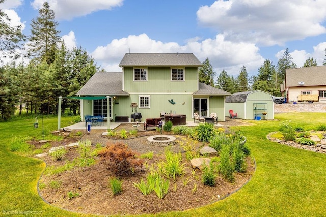 1629 S Royal St, Spokane, WA 99224 - back of house featuring a patio, an outdoor fire pit, a yard, an outdoor structure, and a shingled roof
