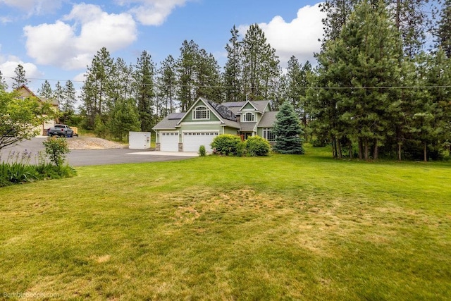 1629 S Royal St, Spokane, WA 99224 - view of front of house with asphalt driveway, roof mounted solar panels, a front yard, and an attached garage