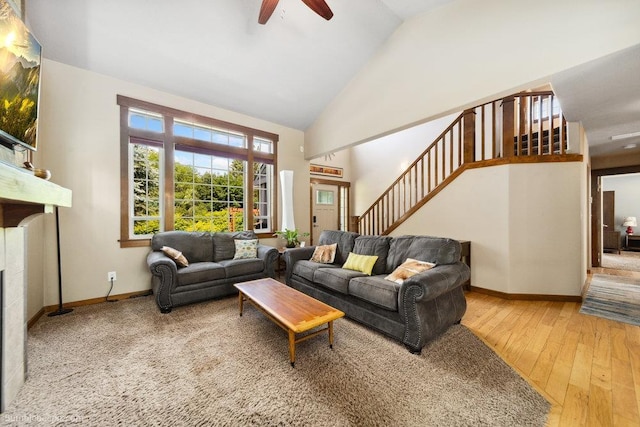 1629 S Royal St, Spokane, WA 99224 - living area with stairway, a ceiling fan, high vaulted ceiling, hardwood / wood-style flooring, and a tiled fireplace