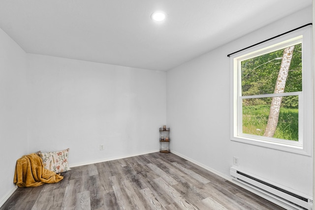 610 N 1st St, Springdale, WA 99173 - empty room with baseboard heating, wood finished floors, and recessed lighting