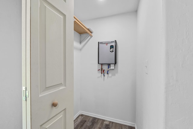 610 N 1st St, Springdale, WA 99173 - walk in closet featuring dark wood-style flooring and water heater