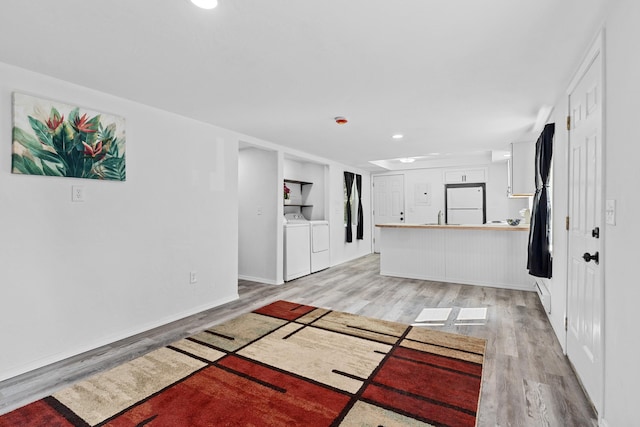 610 N 1st St, Springdale, WA 99173 - unfurnished living room with light wood-type flooring, separate washer and dryer, and recessed lighting