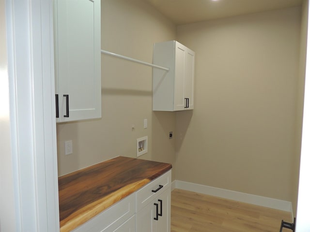 516 SW Alder St, Wilbur, WA 99185 - laundry area featuring electric dryer hookup, cabinet space, light wood-style floors, and hookup for a washing machine