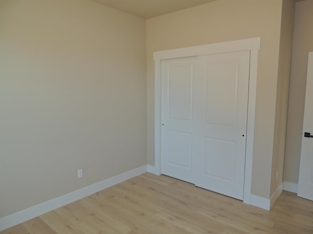 516 SW Alder St, Wilbur, WA 99185 - unfurnished bedroom with light wood-style floors and a closet