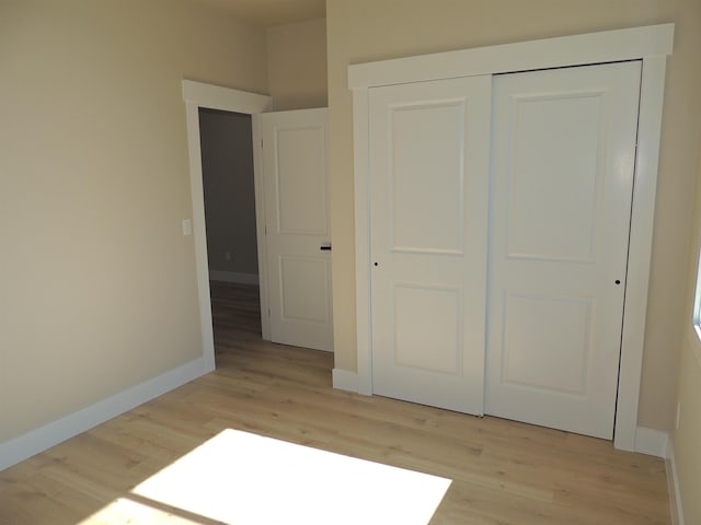 516 SW Alder St, Wilbur, WA 99185 - unfurnished bedroom with light wood finished floors and a closet