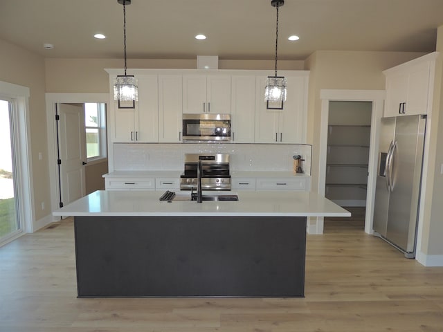 516 SW Alder St, Wilbur, WA 99185 - kitchen with stainless steel appliances, plenty of natural light, decorative backsplash, light countertops, and recessed lighting