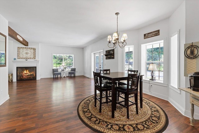 12710 E Kronquist Rd, Mead, WA 99021 - dining space with a chandelier, dark wood finished floors, and a lit fireplace