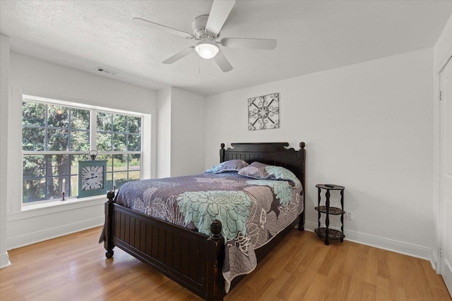 12710 E Kronquist Rd, Mead, WA 99021 - bedroom with wood finished floors and a ceiling fan