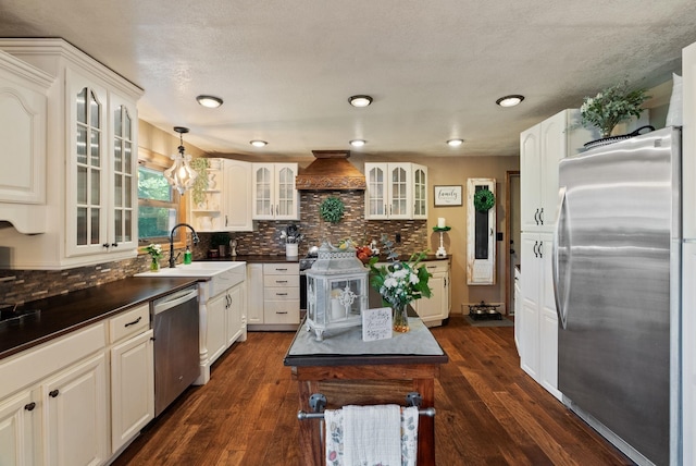 25210 E Bradshaw Rd, Fairfield, WA 99012 - kitchen with appliances with stainless steel finishes, dark countertops, tasteful backsplash, custom range hood, and recessed lighting