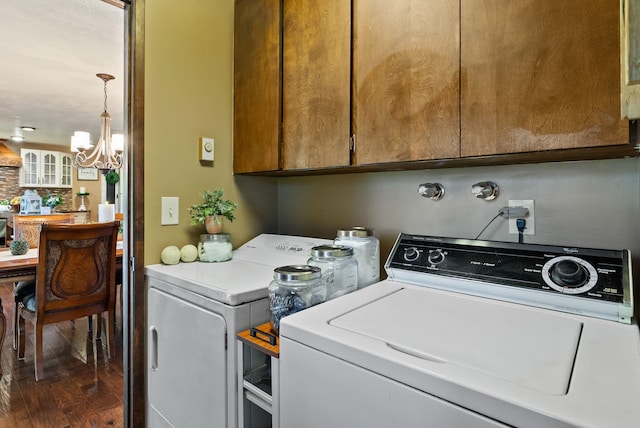 25210 E Bradshaw Rd, Fairfield, WA 99012 - laundry area with washing machine and clothes dryer, a chandelier, cabinet space, and dark wood-style flooring