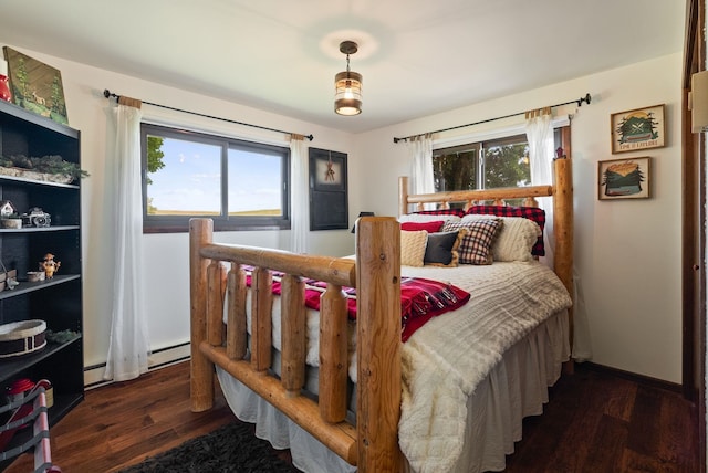 25210 E Bradshaw Rd, Fairfield, WA 99012 - bedroom featuring wood finished floors, a baseboard heating unit, and baseboard heating
