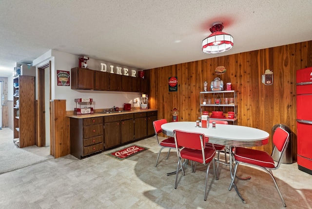 25210 E Bradshaw Rd, Fairfield, WA 99012 - dining room with light floors, wooden walls, and a textured ceiling