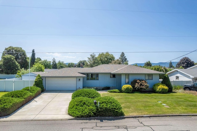 14006 E Cataldo Ave, Spokane Valley, WA 99216 - view of front of house featuring a garage, concrete driveway, and a mountain view