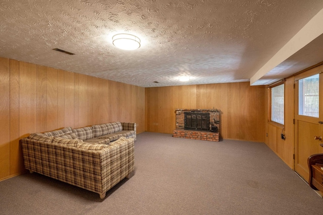 14006 E Cataldo Ave, Spokane Valley, WA 99216 - carpeted living room featuring a textured ceiling, a brick fireplace, and wooden walls
