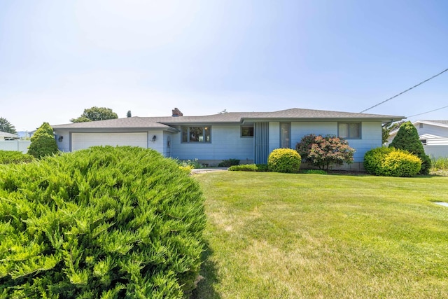 14006 E Cataldo Ave, Spokane Valley, WA 99216 - view of front of property featuring a garage, a front lawn, and a chimney