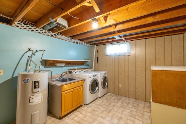 14006 E Cataldo Ave, Spokane Valley, WA 99216 - washroom with water heater, cabinet space, light flooring, washer and clothes dryer, and wooden walls