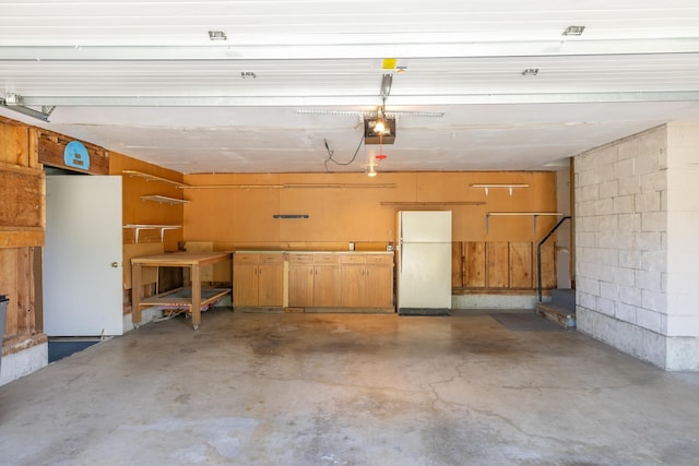 14006 E Cataldo Ave, Spokane Valley, WA 99216 - garage with freestanding refrigerator, a garage door opener, and concrete block wall