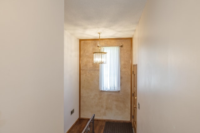 14006 E Cataldo Ave, Spokane Valley, WA 99216 - corridor with a chandelier, a textured ceiling, and wood finished floors