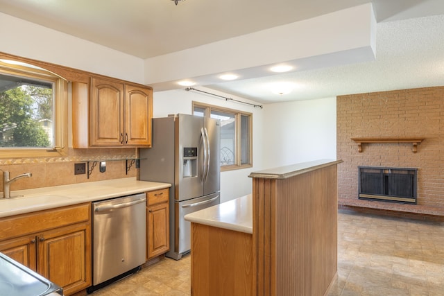 14006 E Cataldo Ave, Spokane Valley, WA 99216 - kitchen featuring stainless steel appliances, a center island, brown cabinets, and light countertops