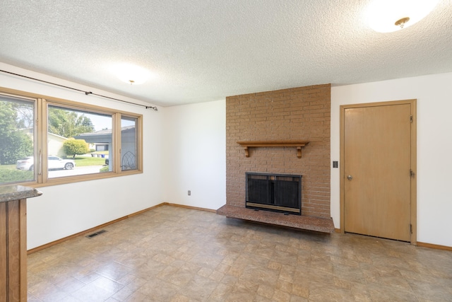 14006 E Cataldo Ave, Spokane Valley, WA 99216 - unfurnished living room featuring a textured ceiling and a fireplace