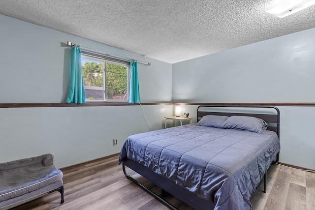 13015 E Mallon Ct, Spokane Valley, WA 99216 - bedroom featuring wood finished floors and a textured ceiling