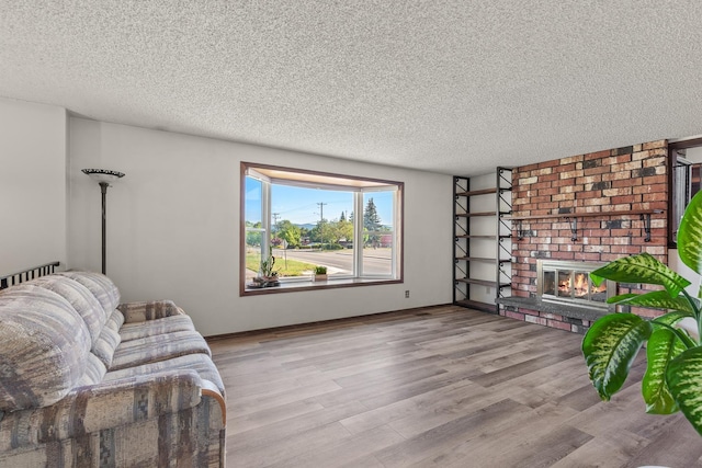13015 E Mallon Ct, Spokane Valley, WA 99216 - living area with a textured ceiling, wood finished floors, and a fireplace