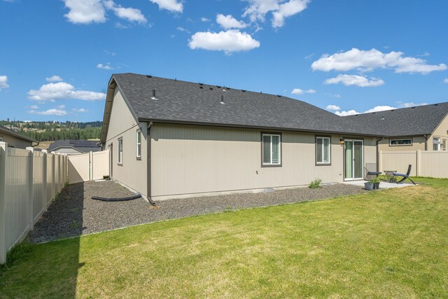 14520 E Everett Ct, Spokane Valley, WA 99216 - rear view of house with a fenced backyard, a shingled roof, and a patio