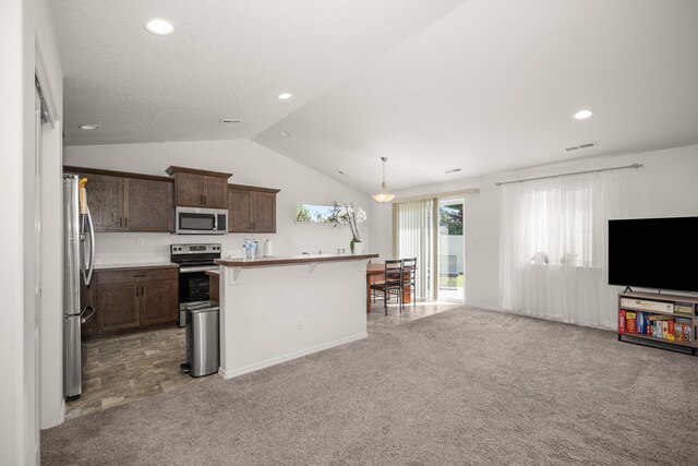 14520 E Everett Ct, Spokane Valley, WA 99216 - kitchen with appliances with stainless steel finishes, a kitchen bar, lofted ceiling, open floor plan, and dark brown cabinetry