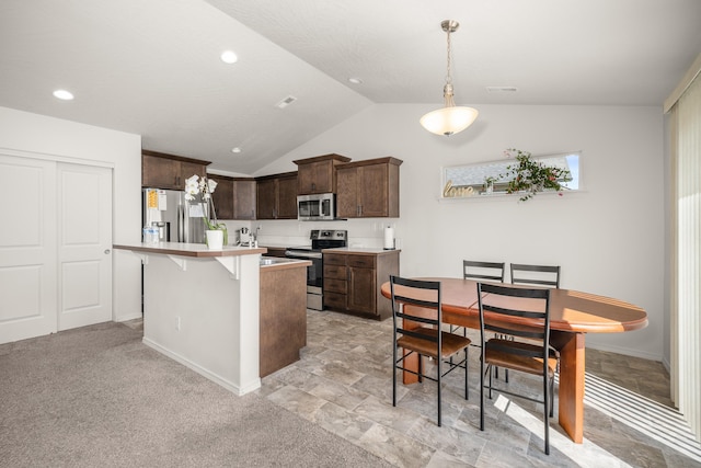 14520 E Everett Ct, Spokane Valley, WA 99216 - kitchen featuring appliances with stainless steel finishes, dark brown cabinets, lofted ceiling, light countertops, and pendant lighting