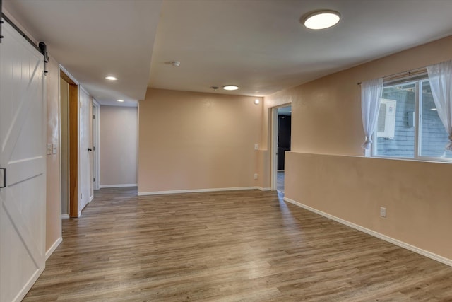 1411 Sinclair St, Davenport, WA 99122 - empty room with a barn door, light wood-style floors, and recessed lighting