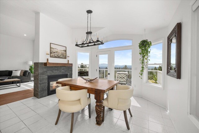 8422 E Sandlewood Ln, Spokane, WA 99217 - dining space featuring plenty of natural light, a fireplace, light tile patterned floors, lofted ceiling, and recessed lighting