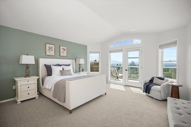 8422 E Sandlewood Ln, Spokane, WA 99217 - bedroom with access to exterior, vaulted ceiling, multiple windows, and light carpet