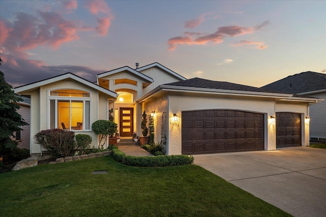 8422 E Sandlewood Ln, Spokane, WA 99217 - view of front of home with an attached garage, concrete driveway, a front lawn, and stucco siding