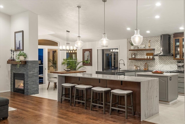 8422 E Sandlewood Ln, Spokane, WA 99217 - kitchen featuring wall chimney range hood, a large island, backsplash, gray cabinetry, and open shelves