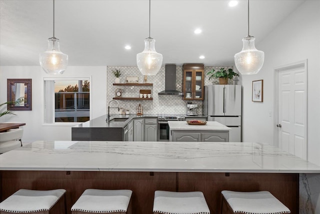 8422 E Sandlewood Ln, Spokane, WA 99217 - kitchen featuring electric stove, wall chimney range hood, freestanding refrigerator, a center island, and tasteful backsplash